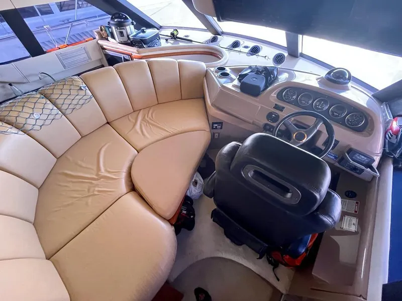 Slide: The Image of Interior of 2000 Carver 45 Voyager yacht with beige seating and control panel. - 4