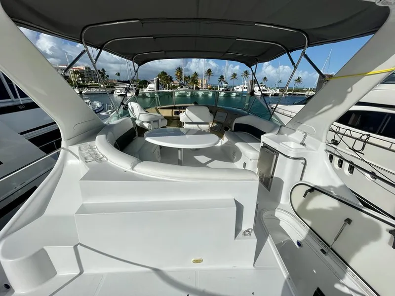 Slide: The Image of 2000 Carver 45 Voyager yacht with spacious deck and seating area in marina. - 6
