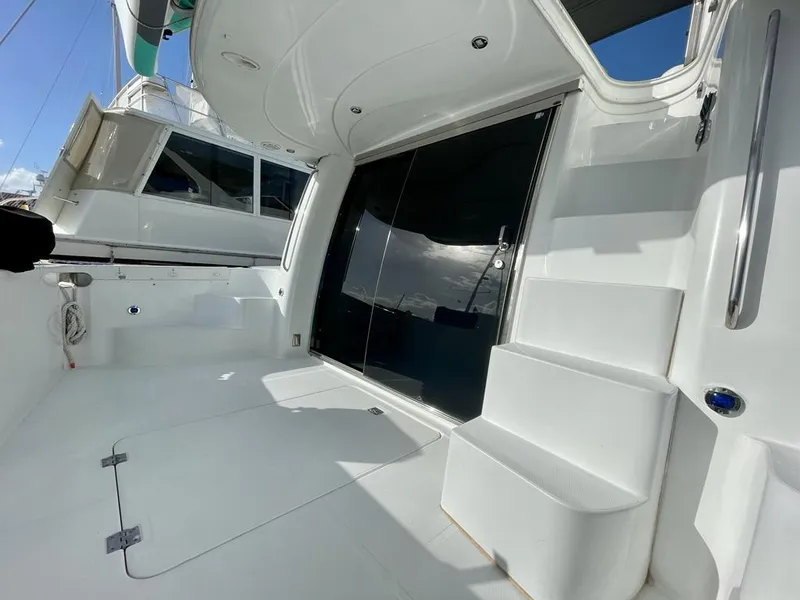 Slide: The Image of 2000 Carver 45 Voyager yacht deck with sleek white design and modern features. - 7