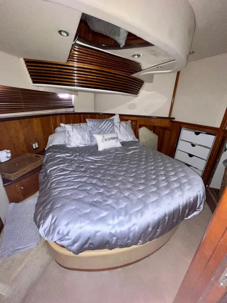 Slide: The Image of Luxurious bedroom in 2000 Carver 45 Voyager yacht with elegant bedding and wood accents. - 8