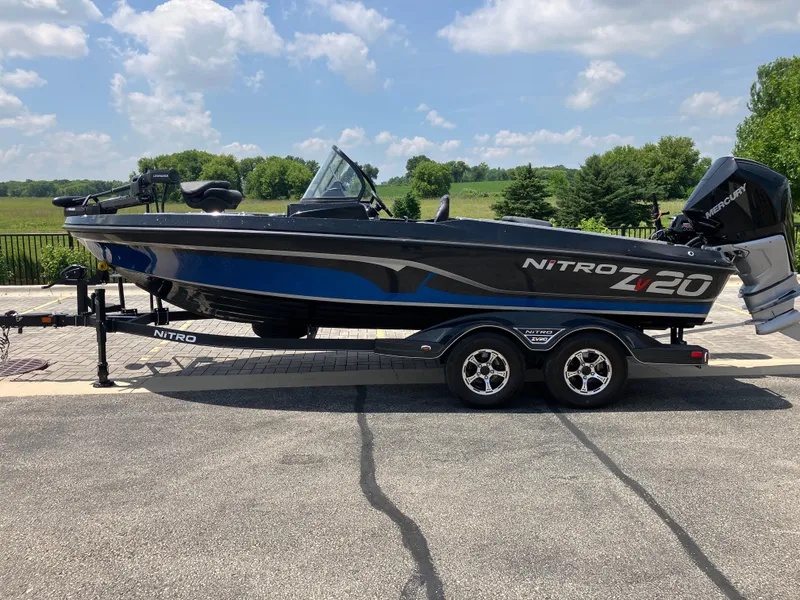 Slide: The Image of 2024 Nitro ZV20 Pro boat on trailer, parked outdoors under a blue sky. - 0