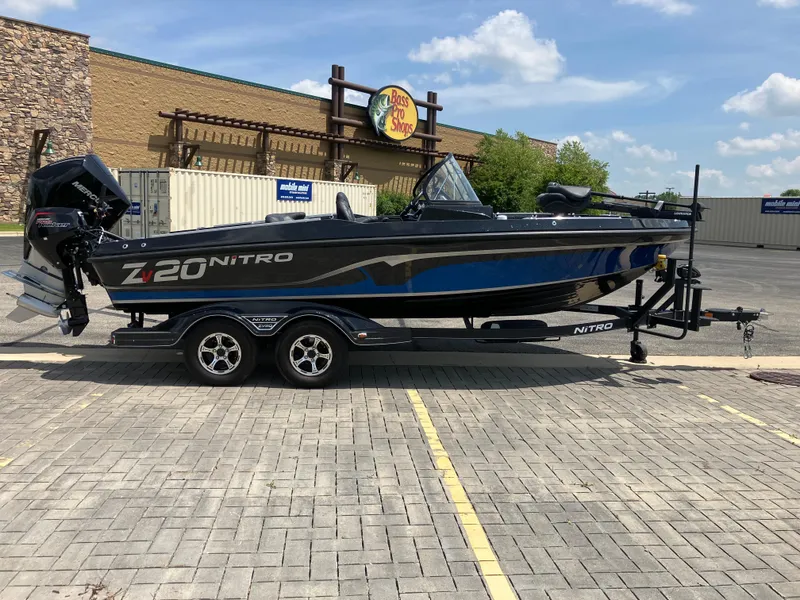 Slide: The Image of 2024 Nitro ZV20 Pro boat on trailer, parked outside Bass Pro Shops. - 1