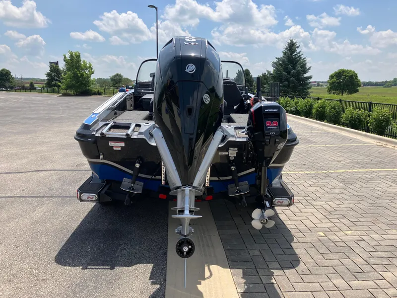 Slide: The Image of 2024 Nitro ZV20 Pro boat with Mercury engine, parked on a sunny day. - 2