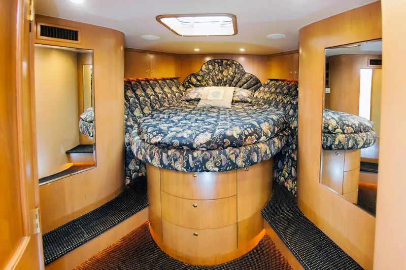 Slide: The Image of Luxurious bedroom interior of 2000 Buddy Davis 78 yacht with floral bedding and wood accents. - 11