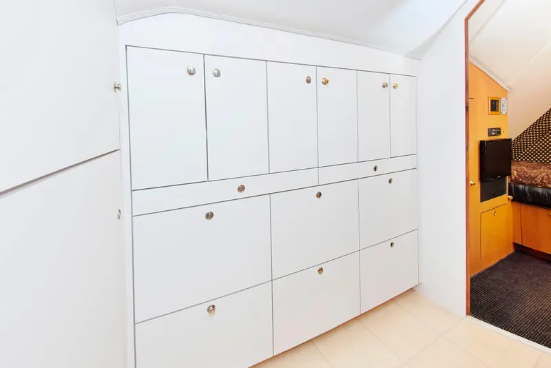 Slide: The Image of White storage cabinets inside a 2000 Buddy Davis 78 yacht interior. - 23