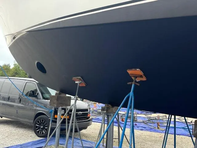 Slide: The Image of Buddy Davis 78 yacht from 2000 on stands, with a van nearby. - 36