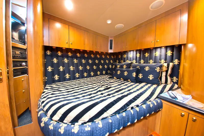 Slide: The Image of Luxurious cabin interior of 2000 Buddy Davis 78 yacht with striped bedding and wood cabinetry. - 13