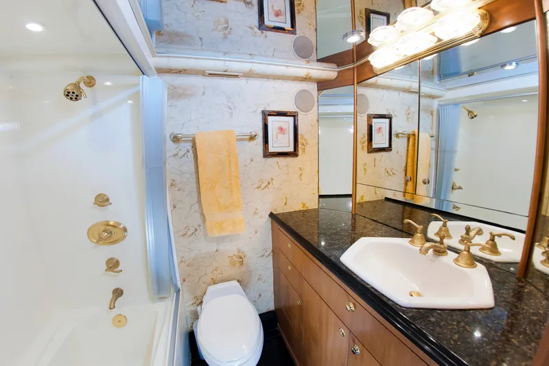 Slide: The Image of Luxurious bathroom in 2000 Buddy Davis 78 yacht with marble walls and gold fixtures. - 16