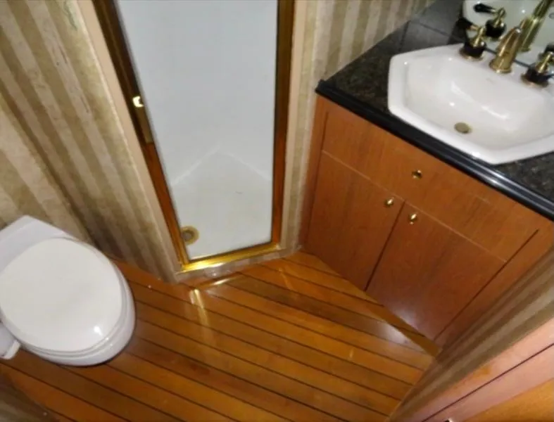 Slide: The Image of Luxury yacht bathroom with wood flooring, shower, and sink. Buddy Davis 78, 2000 model. - 19