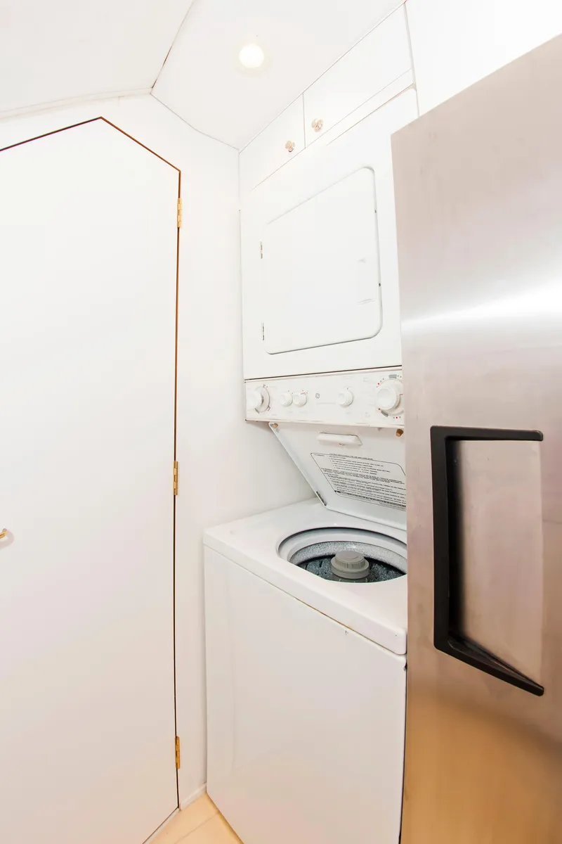 Slide: The Image of Laundry area with stacked washer and dryer on a 2000 Buddy Davis 78 yacht. - 21