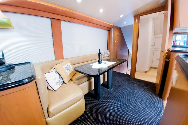 Slide: The Image of Luxurious interior of 2000 Buddy Davis 78 yacht with elegant seating and dining area. - 24