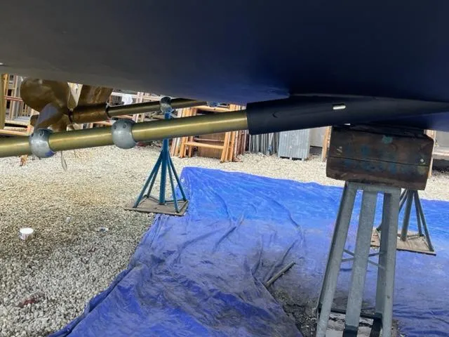 Slide: The Image of Bottom view of a 2000 Buddy Davis 78 boat on stands, showing propeller shaft and supports. - 34