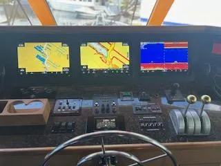 Slide: The Image of Control panel of a 2000 Buddy Davis 78 yacht with navigation screens. - 39