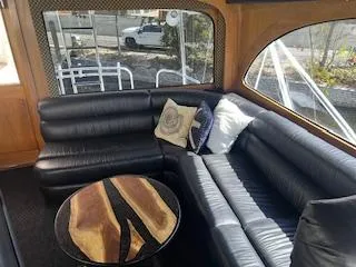 Slide: The Image of Luxurious interior of 2000 Buddy Davis 78 yacht with black leather seating and stylish wooden table. - 43
