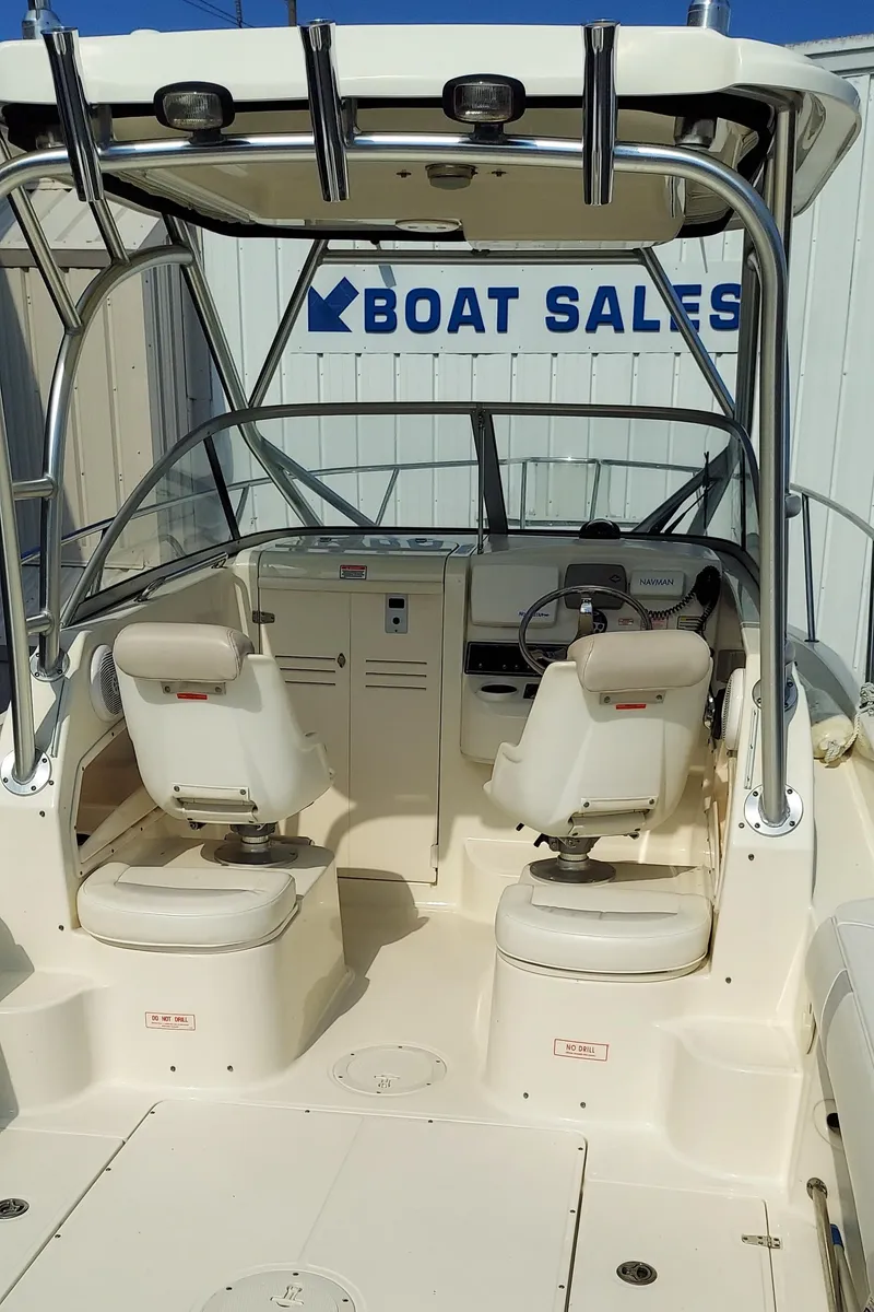 Slide: The Image of 2006 Boston Whaler 235 Conquest boat interior at a sales lot. - 10