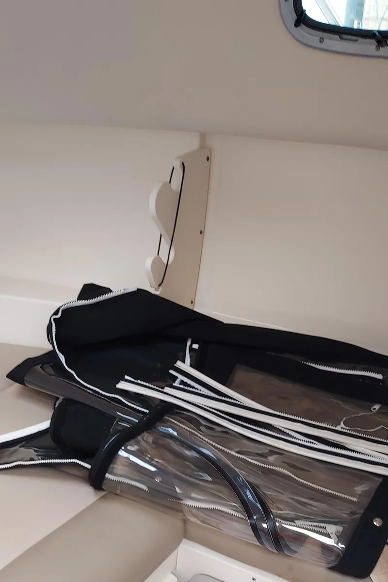 Slide: The Image of Interior of a 2006 Boston Whaler 235 Conquest boat with canvas covers. - 14