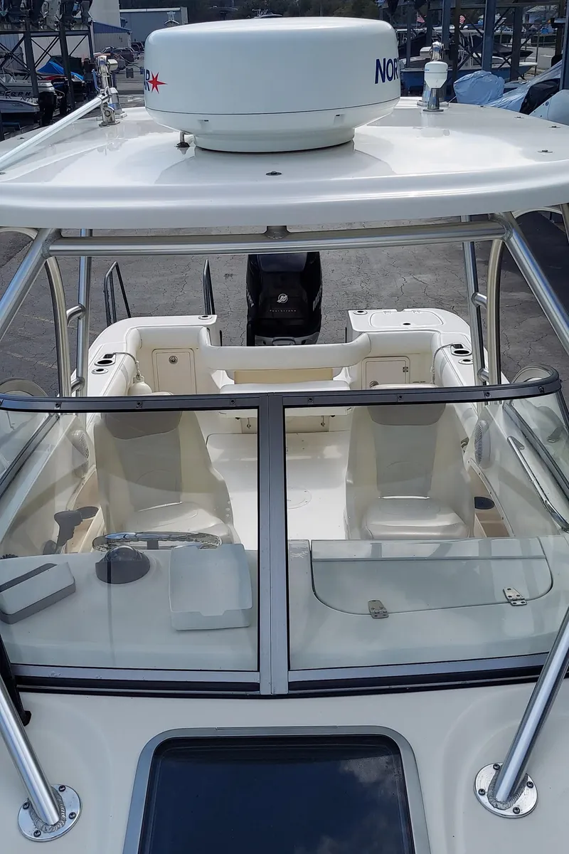 Slide: The Image of 2006 Boston Whaler 235 Conquest boat interior with seating and navigation equipment. - 18