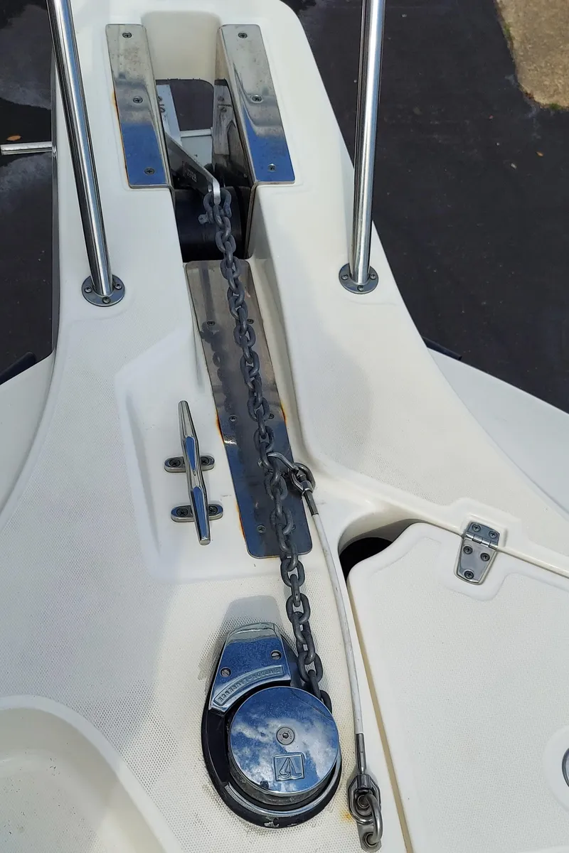 Slide: The Image of 2006 Boston Whaler 235 Conquest anchor windlass and chain on deck. - 19