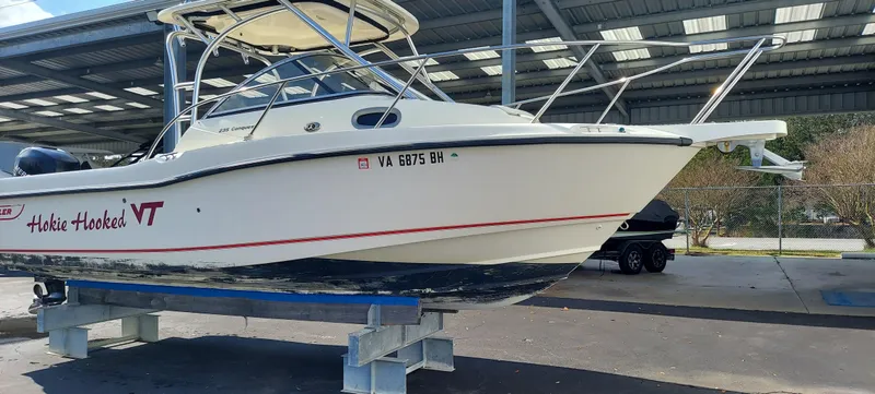 Slide: The Image of 2006 Boston Whaler 235 Conquest boat on blocks in a covered storage area. - 2