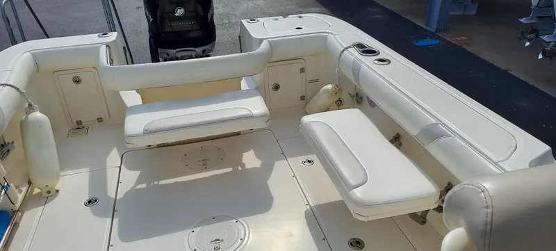 Slide: The Image of 2006 Boston Whaler 235 Conquest boat interior with white cushioned seating. - 7