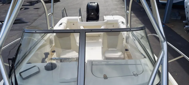 Slide: The Image of 2006 Boston Whaler 235 Conquest boat interior with seating and windshield. - 8