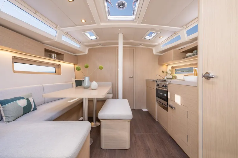 Slide: The Image of Modern interior of 2024 Beneteau Oceanis 37.1 sailboat with dining area and kitchen. - 16