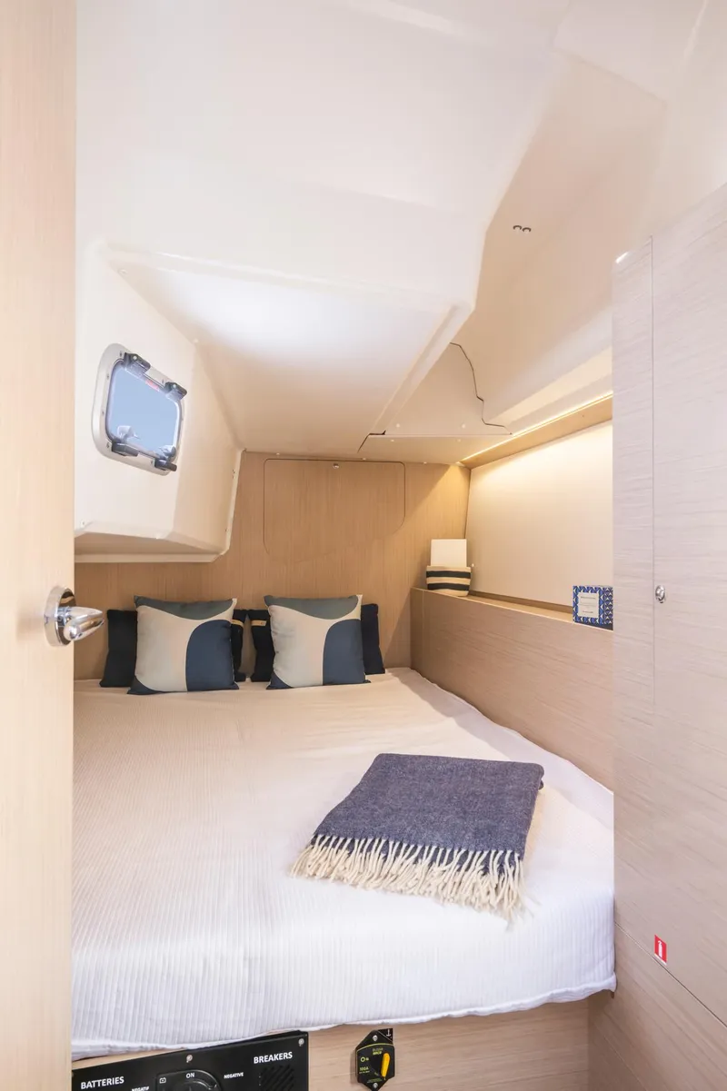 Slide: The Image of 2024 Beneteau Oceanis 37.1 yacht cabin with cozy bed and modern decor. - 20