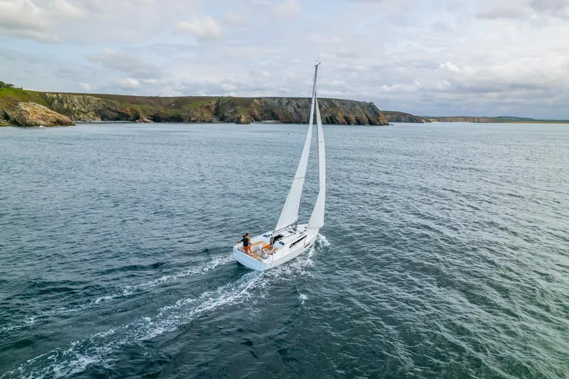 Slide: The Image of 2024 Beneteau Oceanis 37.1 sailing near rocky coastline. - 21