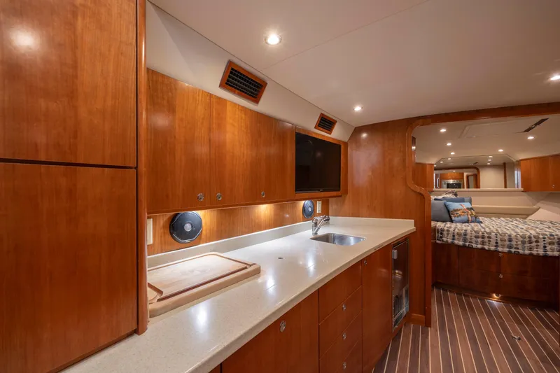 Slide: The Image of 2019 Albemarle 410 Express Fisherman interior with modern kitchen and cozy sleeping area. - 25