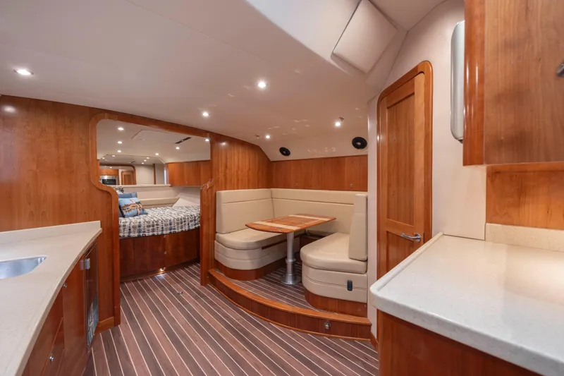 Slide: The Image of 2019 Albemarle 410 Express Fisherman interior with dining area and sleeping quarters. - 26