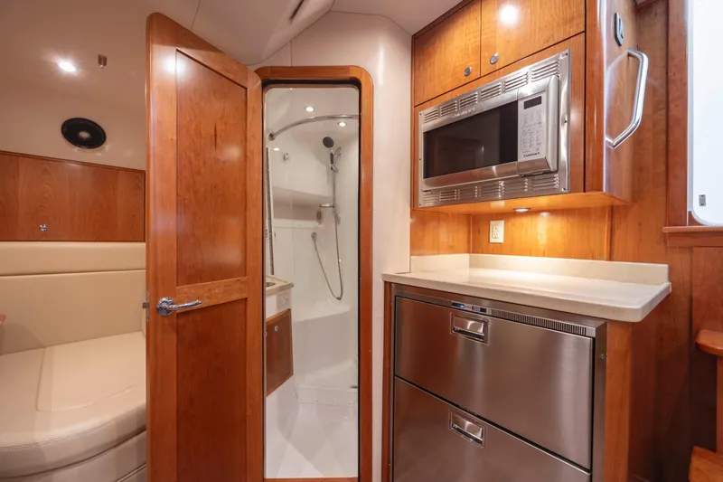 Slide: The Image of 2019 Albemarle 410 Express Fisherman interior with kitchenette and shower. - 29