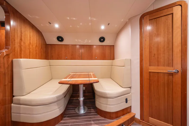 Slide: The Image of 2019 Albemarle 410 Express Fisherman interior with wooden finishes and beige seating. - 33