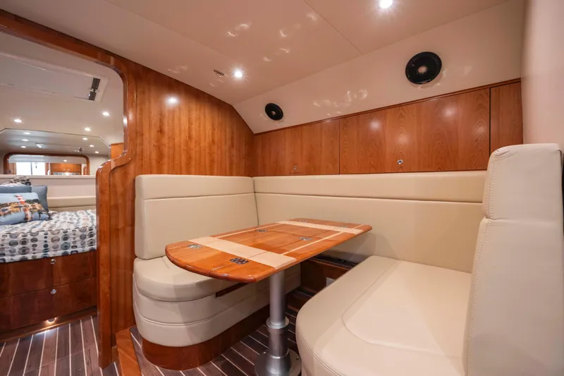 Slide: The Image of 2019 Albemarle 410 Express Fisherman interior with dining area and cozy seating. - 34