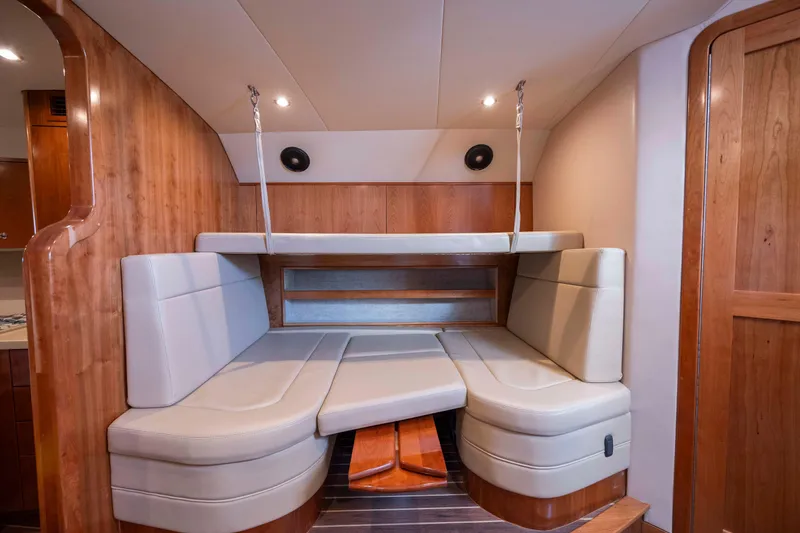 Slide: The Image of 2019 Albemarle 410 Express Fisherman cabin interior with beige seating and wooden accents. - 35