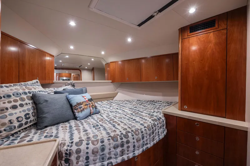 Slide: The Image of 2019 Albemarle 410 Express Fisherman cabin with bed, wooden cabinets, and modern lighting. - 39