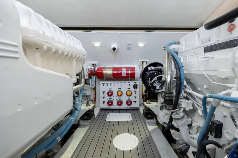 Slide: The Image of 2019 Albemarle 410 Express Fisherman engine room with control panel and fire extinguisher. - 42