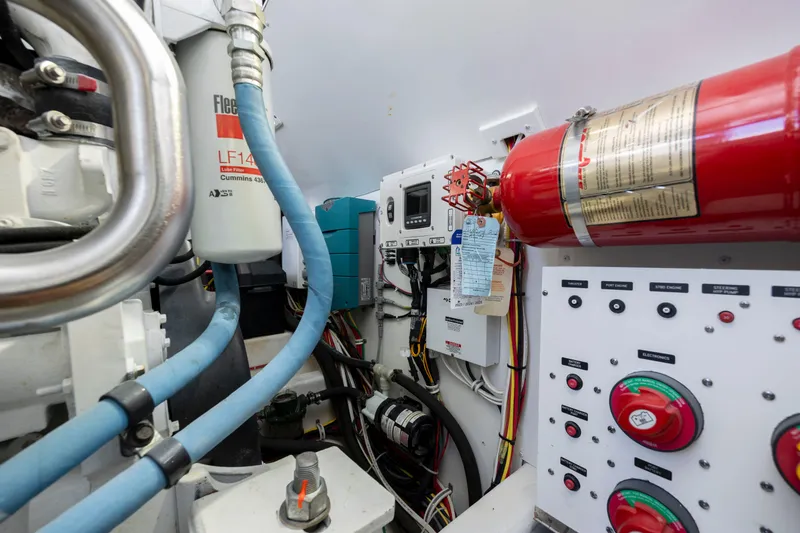 Slide: The Image of Engine room of 2019 Albemarle 410 Express Fisherman with fire extinguisher and control panel. - 43