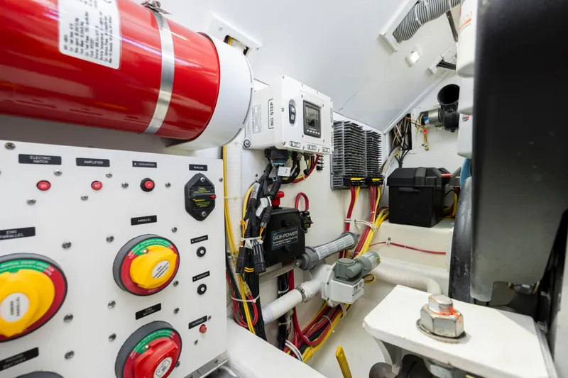 Slide: The Image of Engine room of 2019 Albemarle 410 Express Fisherman with control panels and wiring. - 44