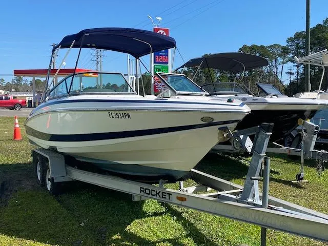 The Image of 2012 Regal 2100 boat on a Rocket trailer at a dealership. - 1