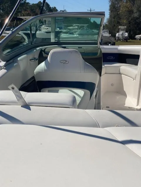 Slide: The Image of 2012 Regal 2100 boat interior with white and blue seating. - 10