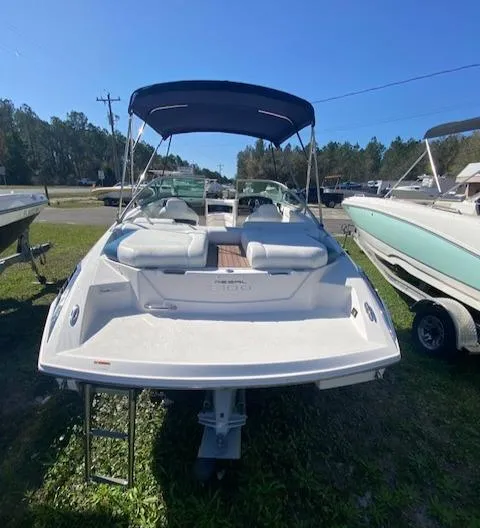 Slide: The Image of 2012 Regal 2100 boat with canopy, docked on grass. - 7
