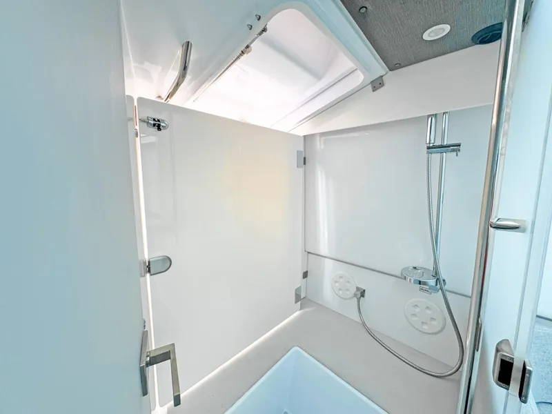 Slide: The Image of 2024 Axopar 37 Sun Top bathroom with modern shower and sleek design. - 24