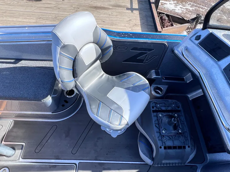 Slide: The Image of 2024 Nitro ZV20 boat interior with a cushioned captain's chair and control panel. - 13