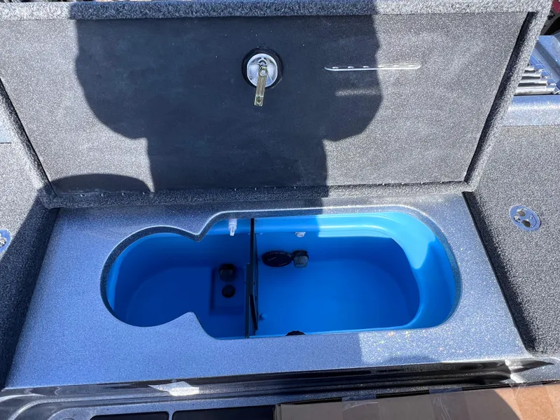 Slide: The Image of 2024 Nitro ZV20 livewell compartment with blue interior and secure lock. - 16