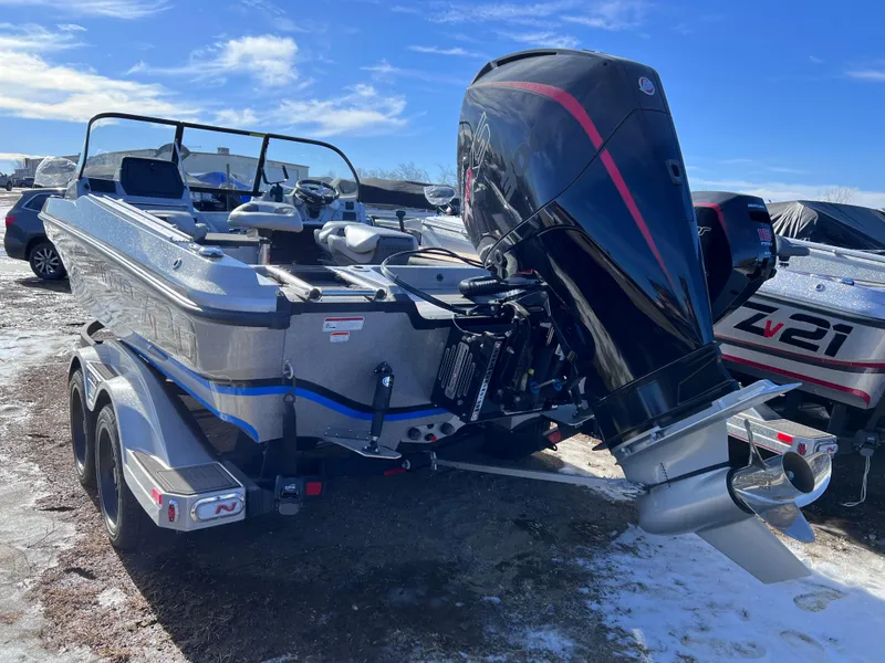 Slide: The Image of 2024 Nitro ZV20 boat with powerful outboard motor on a trailer. - 2