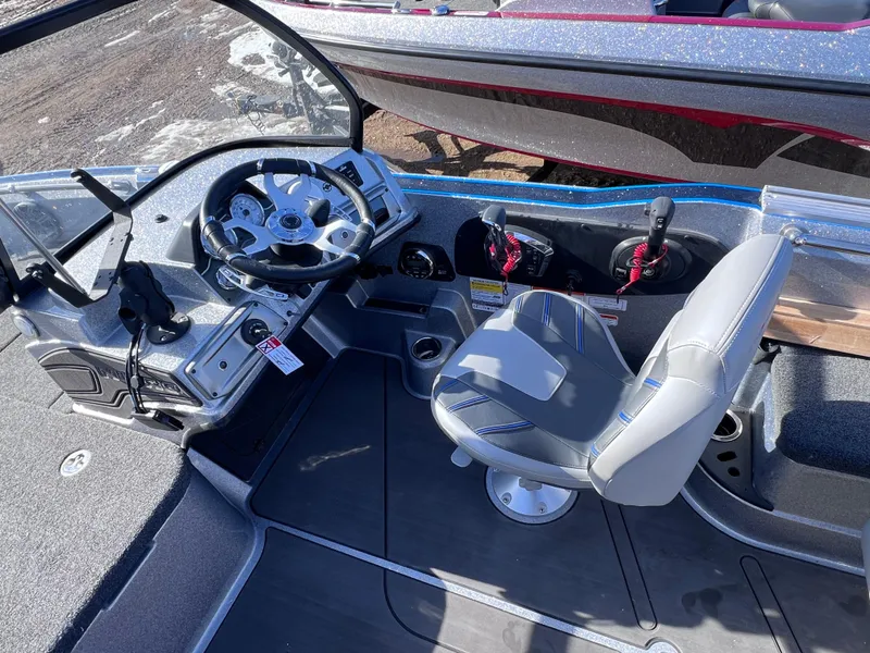 Slide: The Image of 2024 Nitro ZV20 boat cockpit with steering wheel and captain's chair. - 7