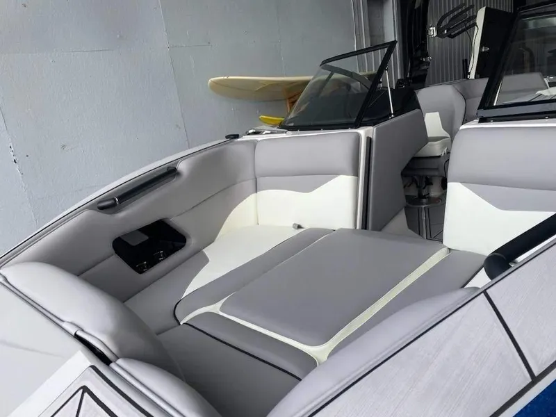 Slide: The Image of 2023 Moomba Mojo boat interior with gray and white seating. - 2