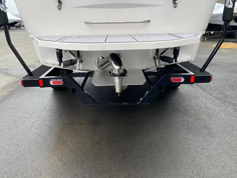 Slide: The Image of 2023 Moomba Mojo boat rear view with trailer and propeller. - 4