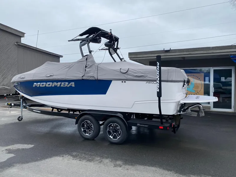 Slide: The Image of 2023 Moomba Mojo boat on trailer with cover in parking lot. - 5