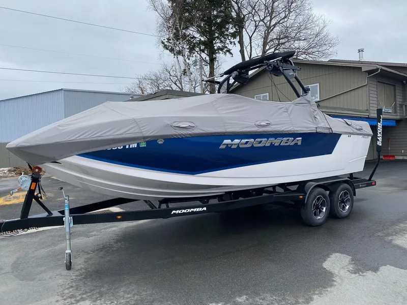 Slide: The Image of 2023 Moomba Mojo boat on trailer with cover, parked outdoors. - 7